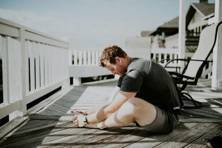 Athlete performing a full-body flexibility and mobility exercise outdoors