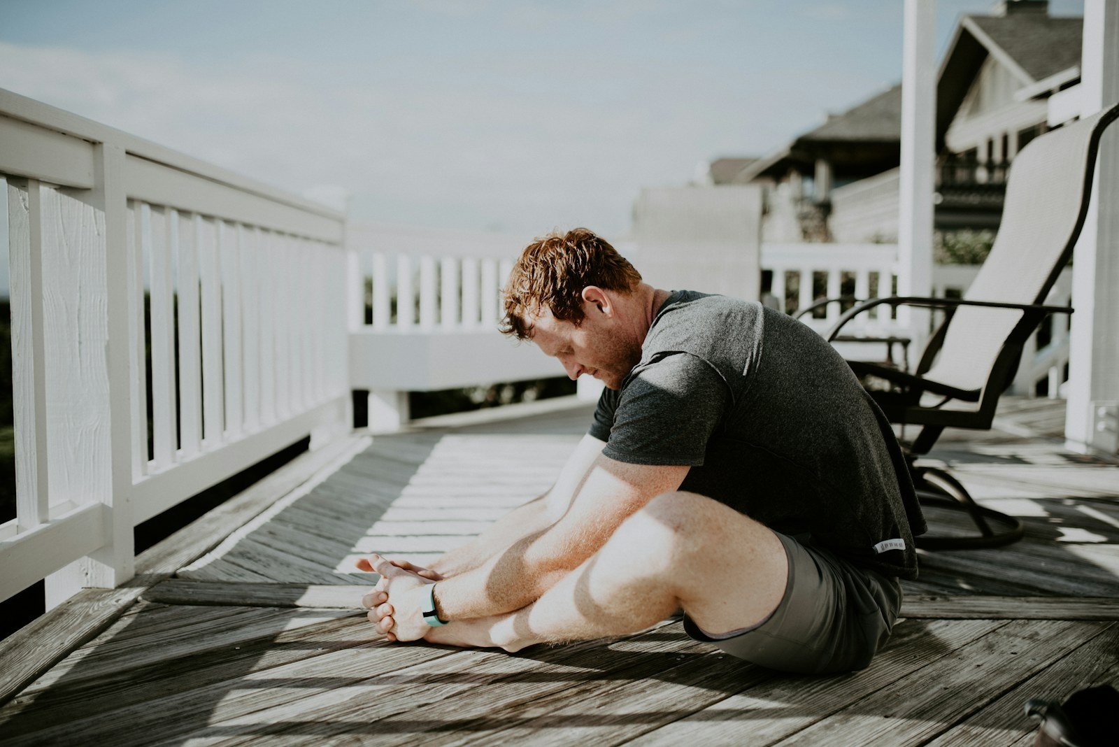 Athlete performing a full-body flexibility and mobility exercise outdoors