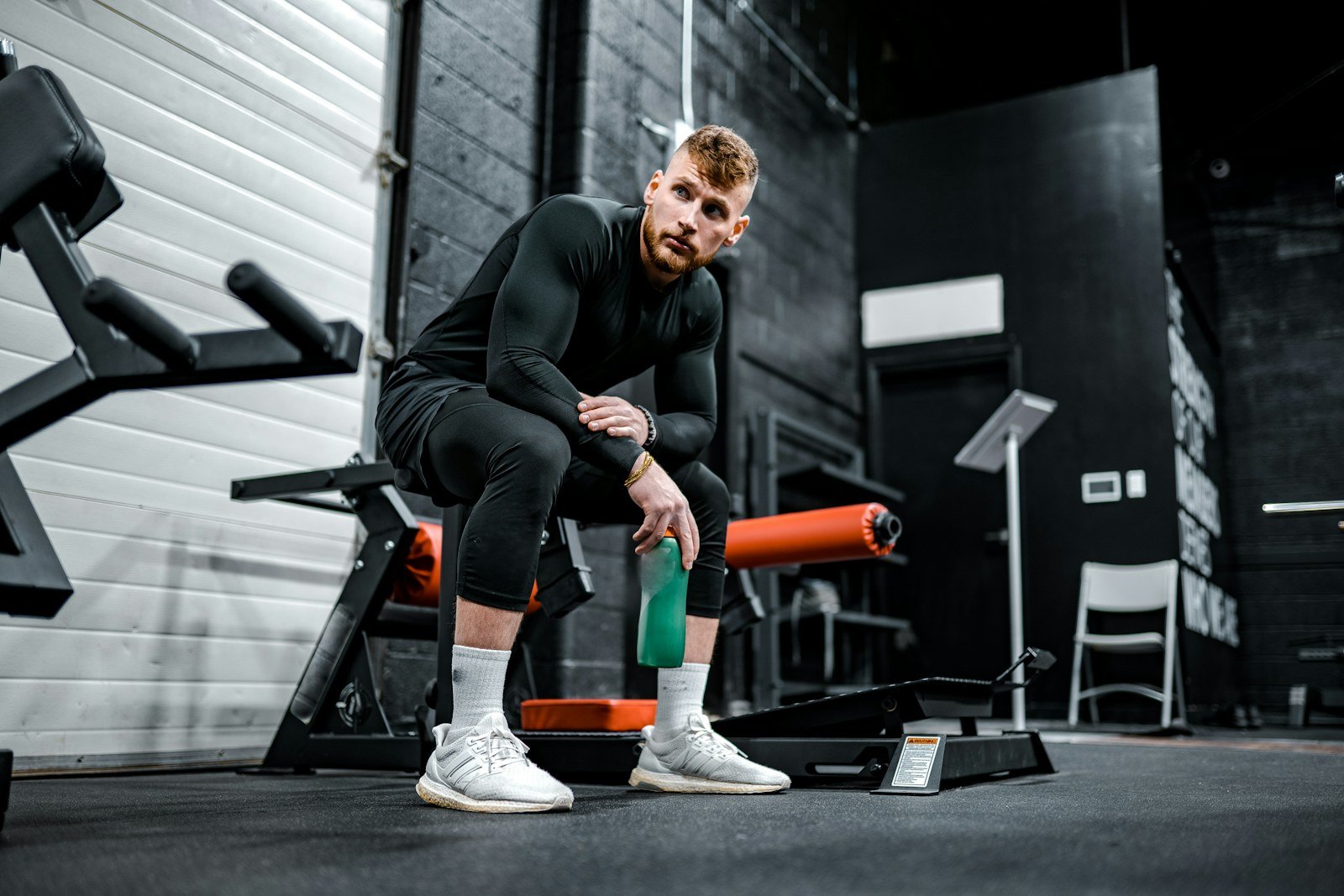 Strength athlete resting between efforts during a gym session