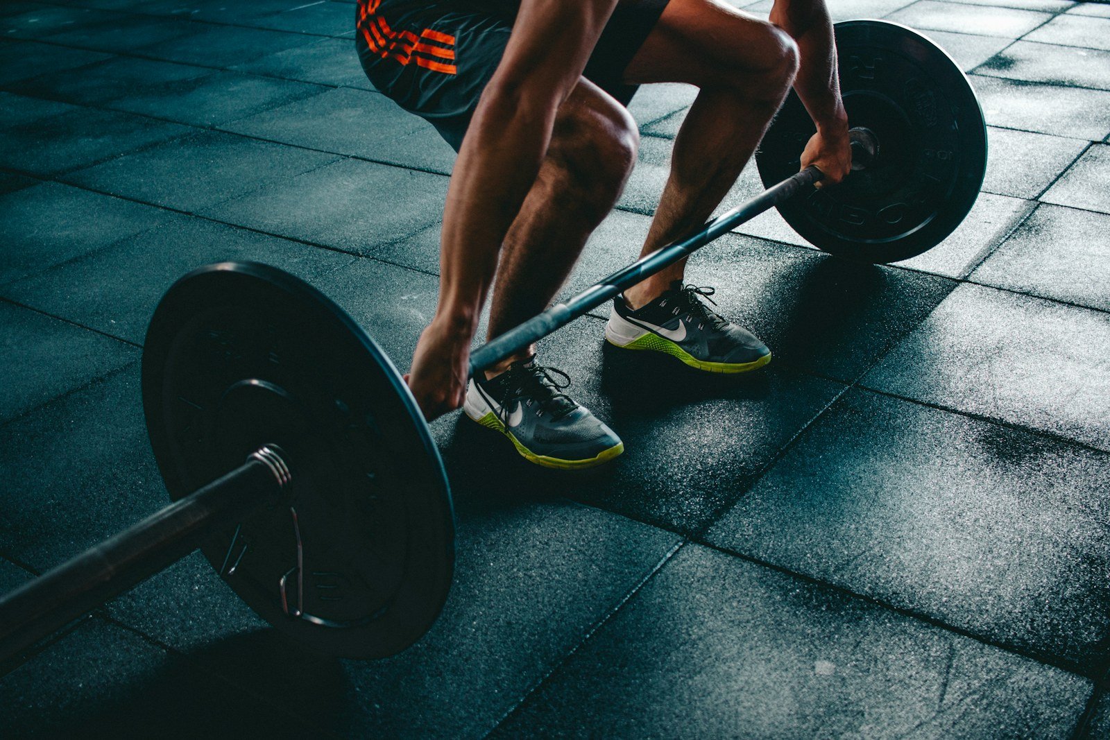 Athlete preparing for barbell strength training in a gym