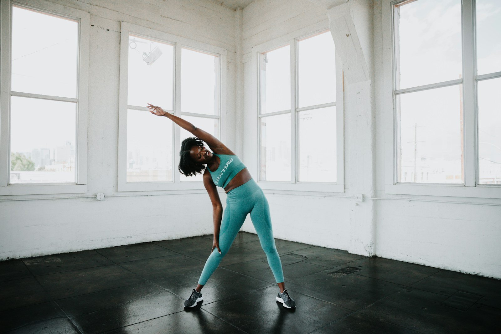 Athlete practising controlled mobility exercises in a gym