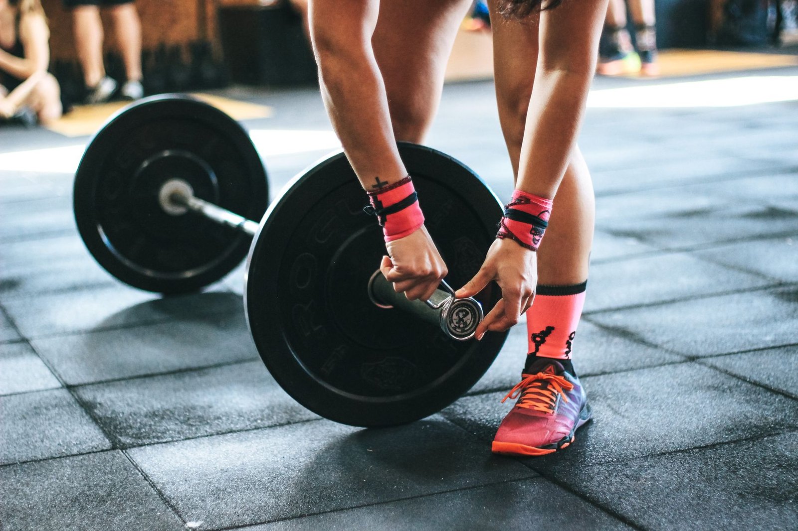 Athlete preparing a barbell before strength training