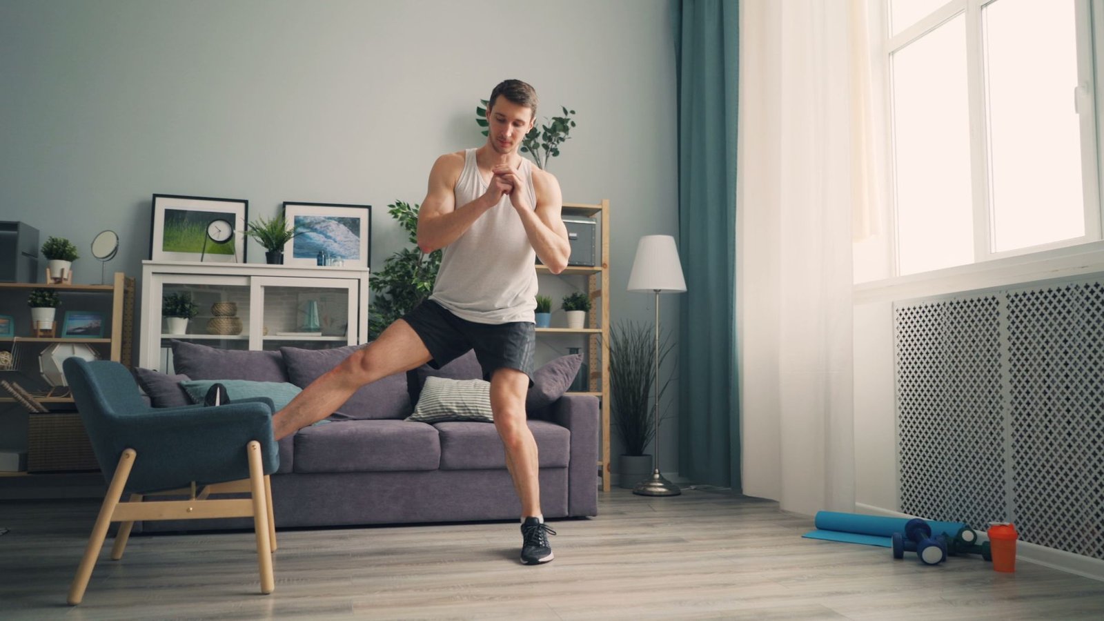 Man performing stretching exercises at home, emphasizing indoor workout routine.