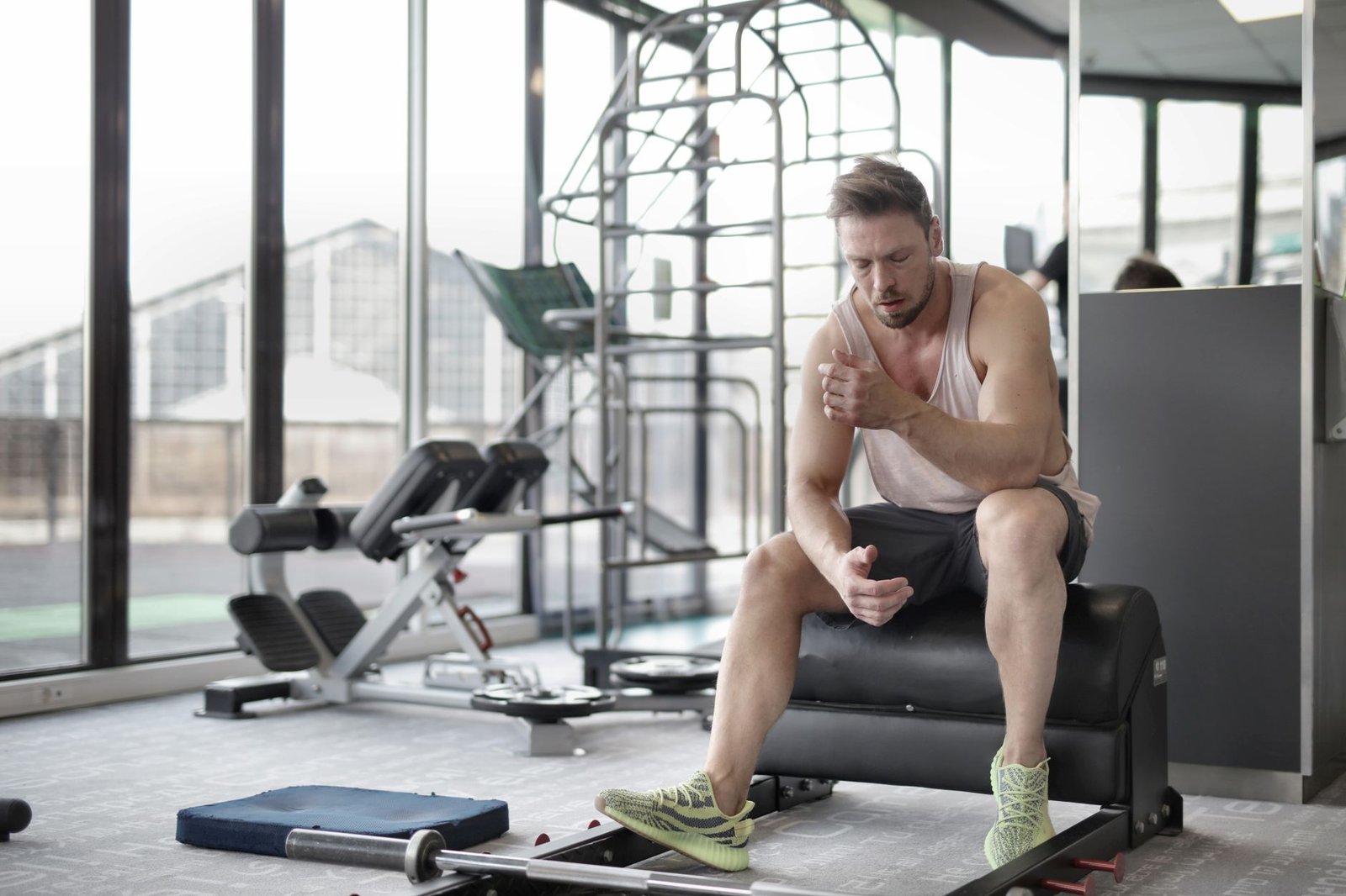 Athlete resting on a bench after strength training